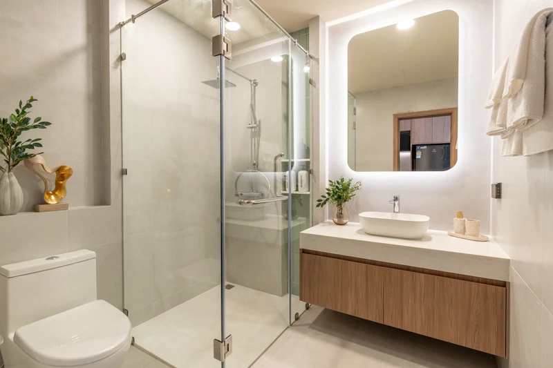 Saint Tropez Naithon — studio A show unit: bathroom with a glass shower and a backlit mirror