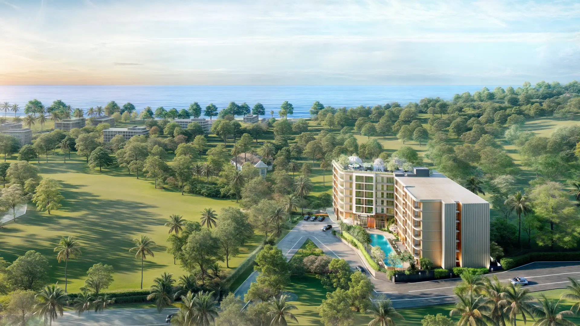 Saint Tropez Naithon von oben: das Gebäude mit Pool im Grün von Nai Thon, die Andamanensee und Sonnenuntergang am Horizont